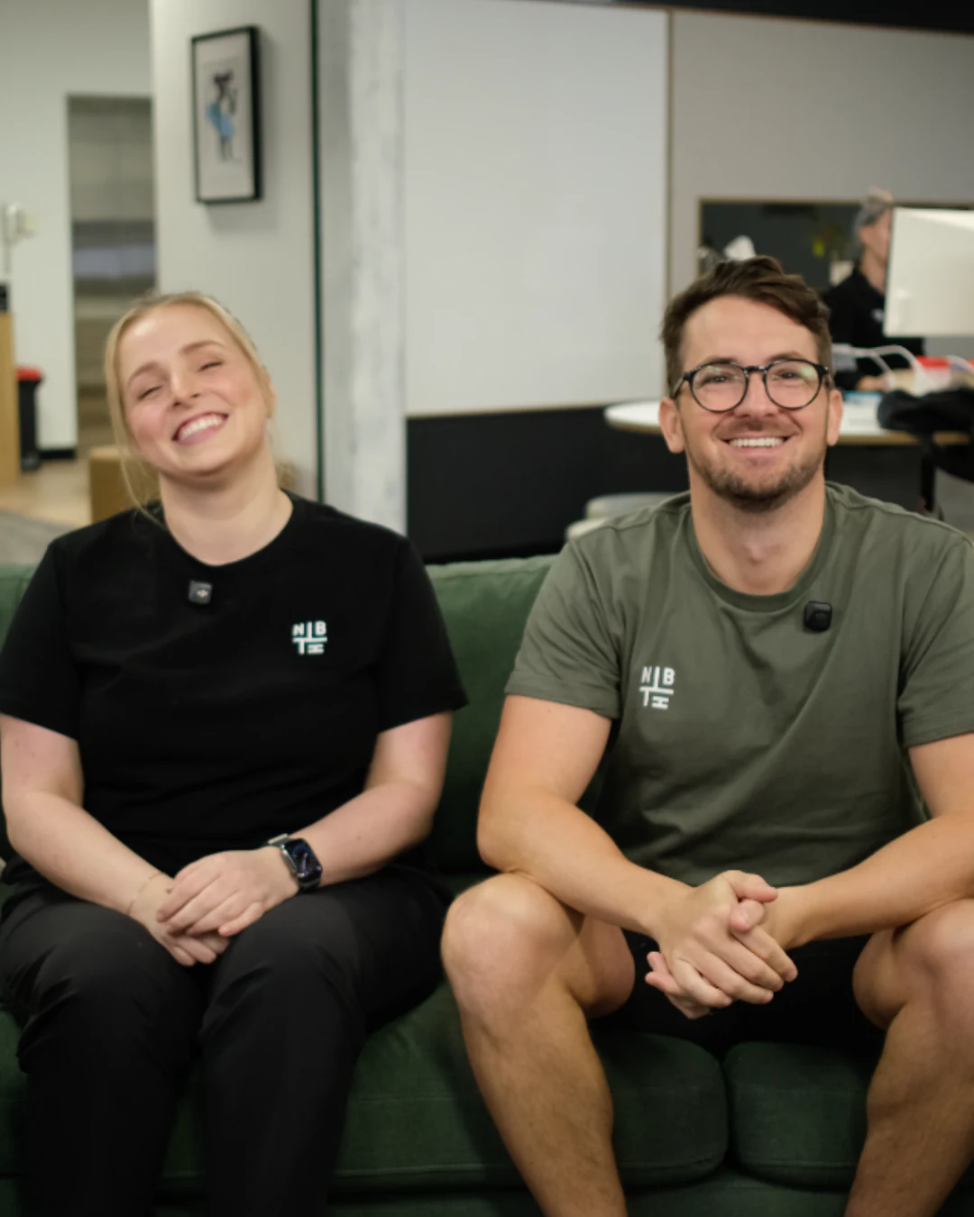 Two Neighbourhood team members sitting on the office couch