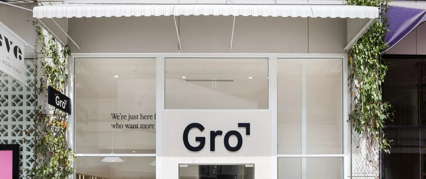 The white shopfront of a Gro Clinics clinic under a scalloped awning, the Gro name above the door and climbing plants either side