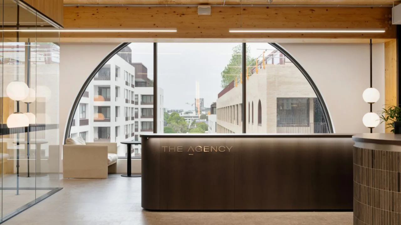 The Agency's Sydney reception, the desk under a tall arched window